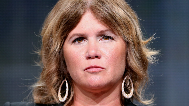 Tracey Gold wearing hoop earrings 