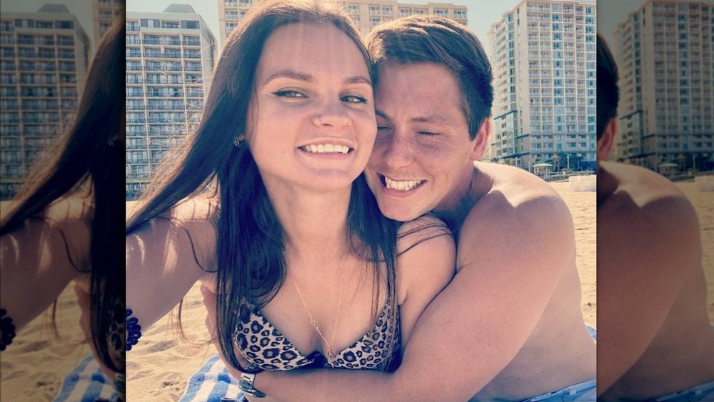 Julia Trubkina and Brandon Gibbs taking a selfie on the beach