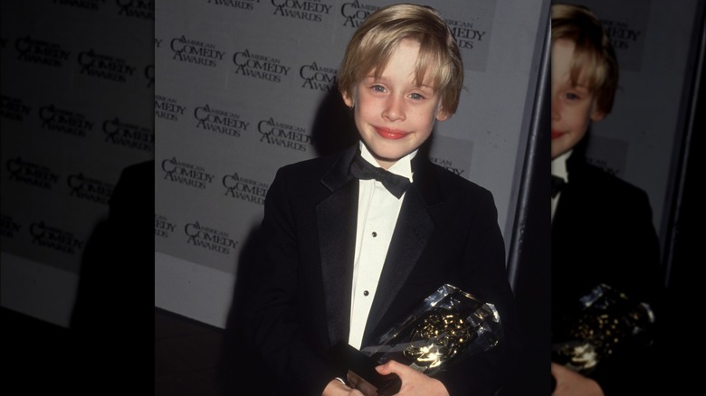 Macaulay Culkin holding an award