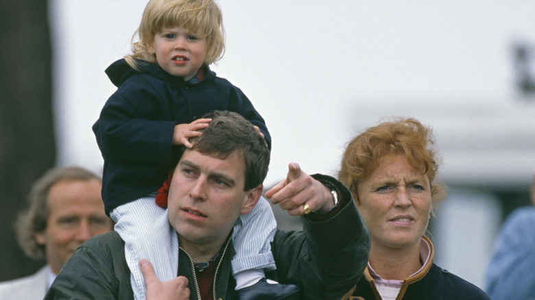 Prince Andrew carrying daughter shoulders