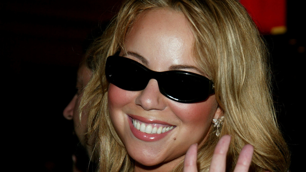 Mariah Carey smiling with sunglasses on