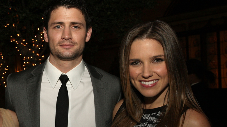 James Lafferty and Sophia Bush posing and smiling together