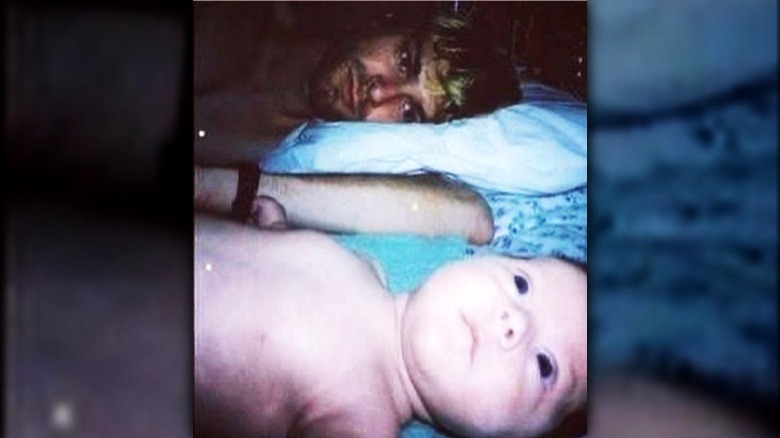 Kurt Cobain posing with Frances as a baby