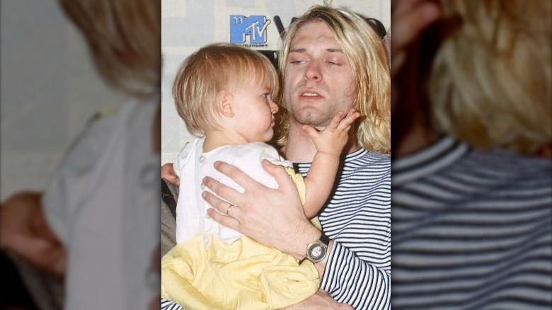 Kurt Cobain cuddling Frances Bean