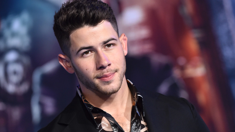 Nick Jonas smiling at event