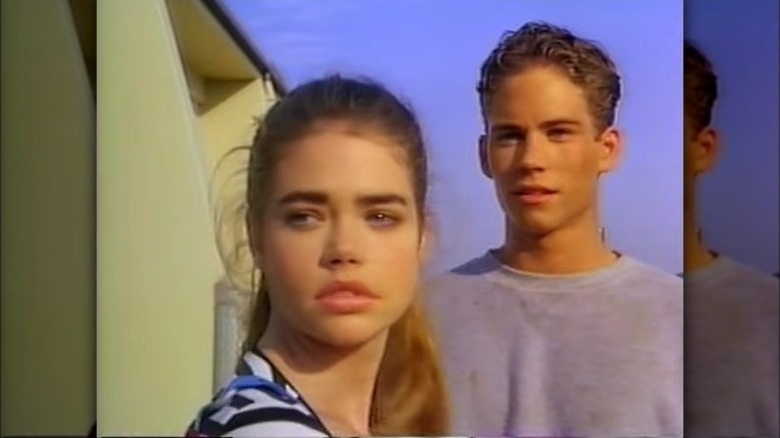 Denise Richards with Paul Walker behind her