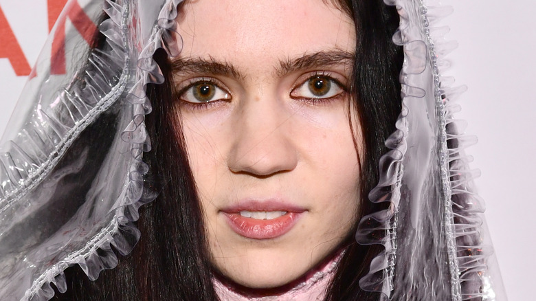 Grimes with brunette hair and veil