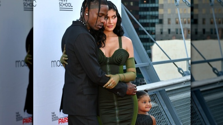 Travis Scott poses with Kylie Jenner and Stormi Webster on the red carpet