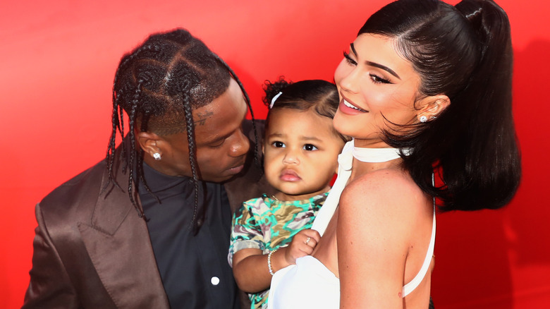 Kylie Jenner and Travis Scott pose on the red carpet with Stormi
