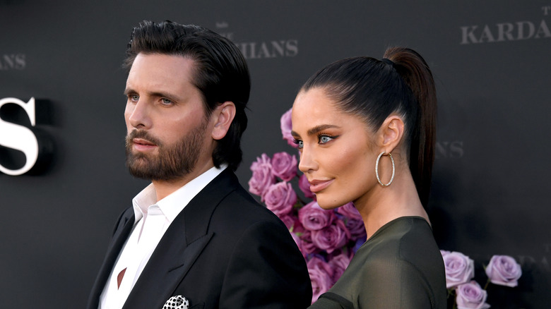 Scott Disick posing on red carpet with Rebecca Donaldson