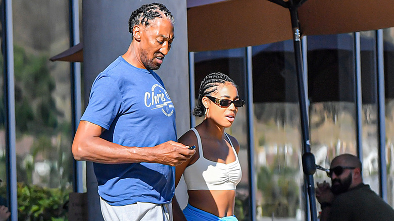 Scottie Pippen and a woman walk down a sidewalk