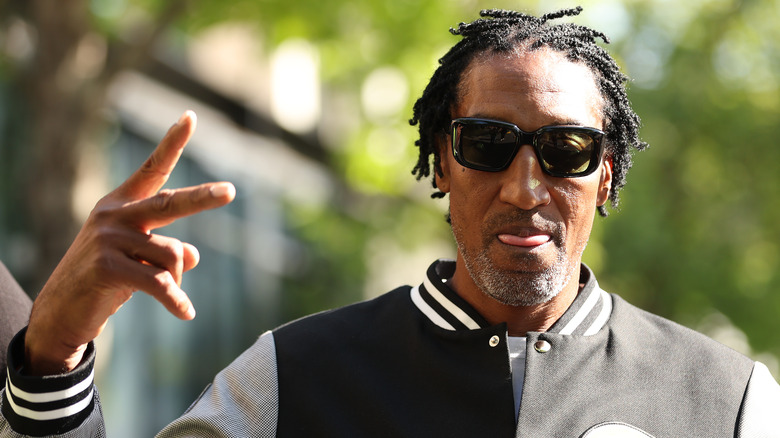 Scottie Pippen giving a peace sign in sunglasses