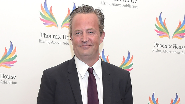 Matthew Perry wearing a suit