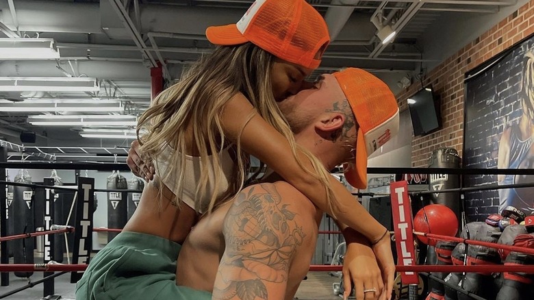 Julia Rose kissing Jake Paul at a boxing arena