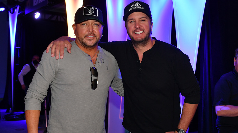 Jason Aldean and Luke Bryan posing together and smiling