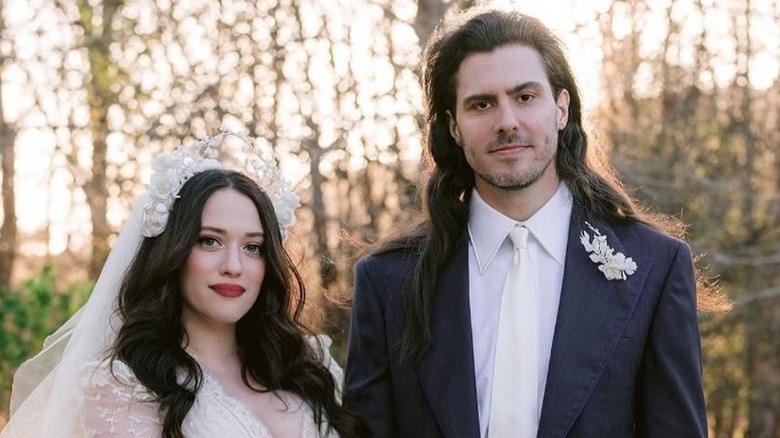 Kat Dennings and Andrew W.K. pose on their wedding day outdoors