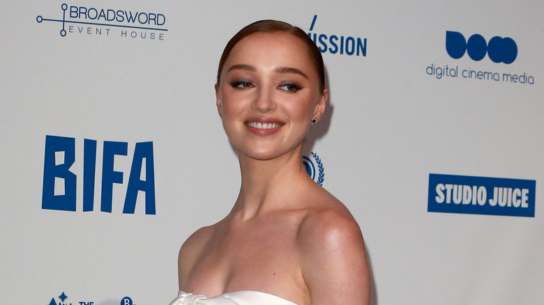 Phoebe Dynevor posing at event