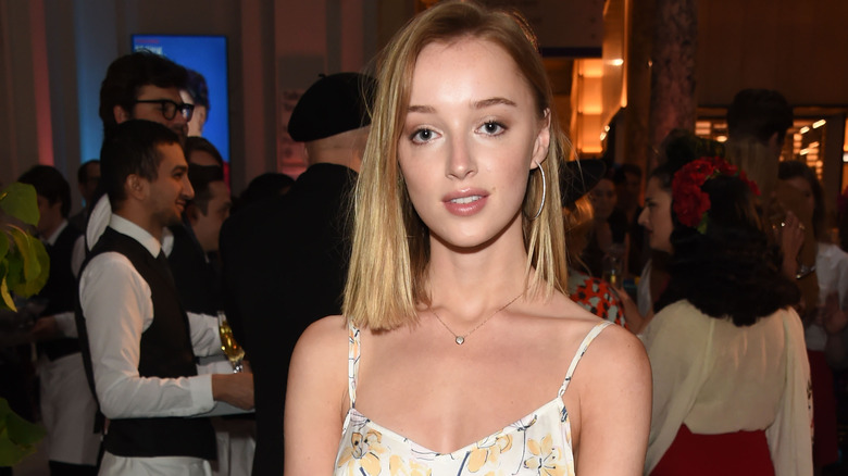 Phoebe Dynevor posing at event