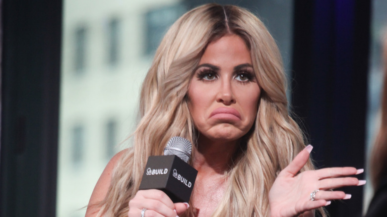 Kim Zolciak shrugs animatedly