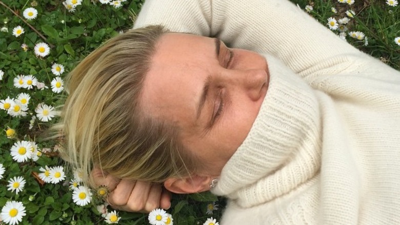 Yolanda Hadid laying on grass