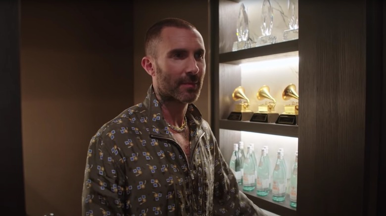 Adam Levine with his Grammys and water bottles