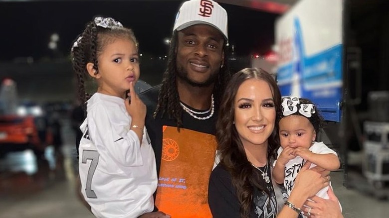 Davante Adams and Devanne Villarreal posing with their two children