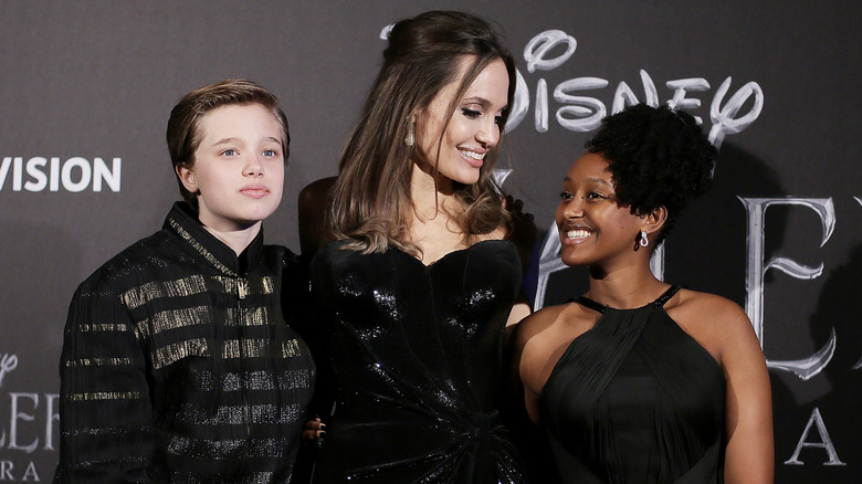 Shiloh Jolie-Pitt, Angelina Jolie, and Zahara Jolie-Pitt posing together