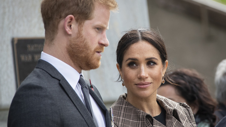 Meghan Markle staring at her husband Prince Harry