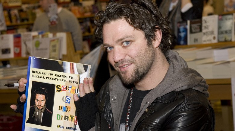 Bam Margera posing with his book