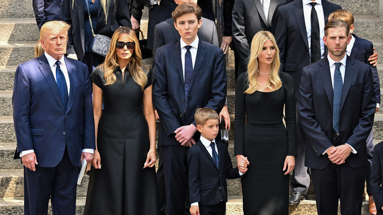 Trump family members posing on steps