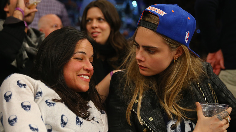 Michelle Rodriguez and Cara Delevingne at a basketball game