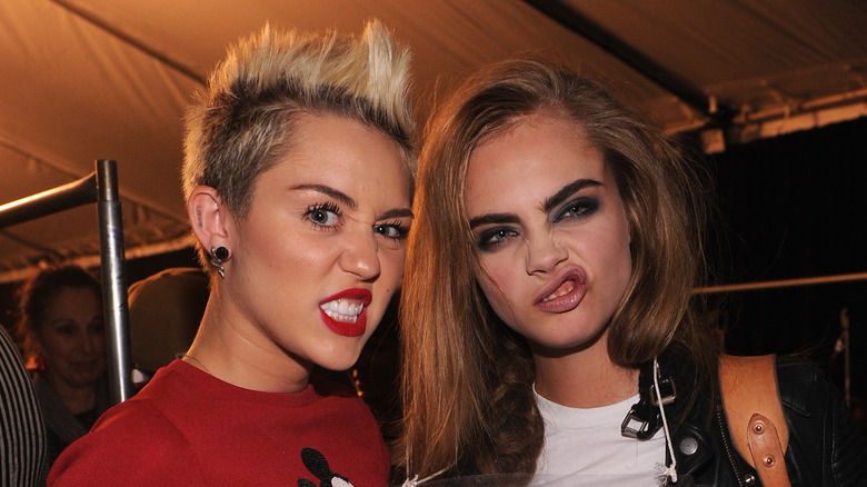 Miley Cyrus and Cara Delevingne pulling faces