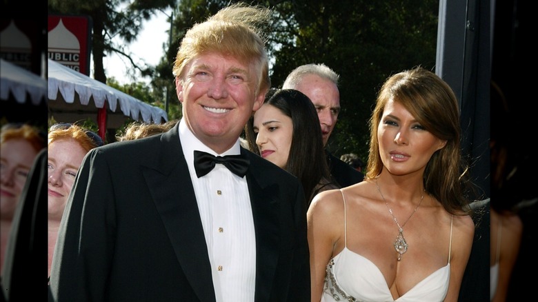 Donald Trump's hair blows up as he poses with Melania Trump at the 2004 Emmys