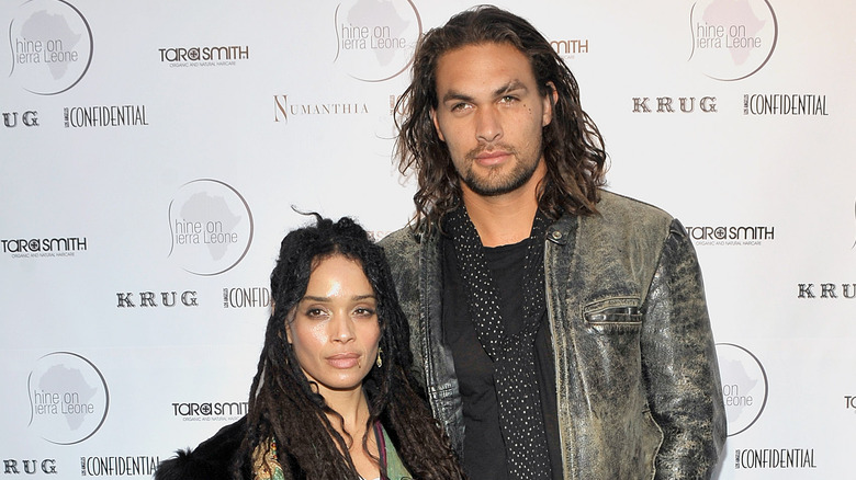 Lisa Bonet and Jason Momoa in front of a step-and-repeat