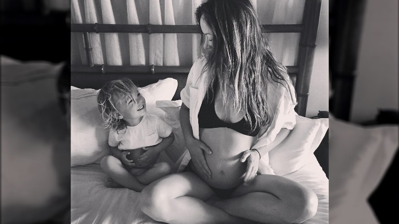 Olivia Wilde with her son Otis and a baby bump
