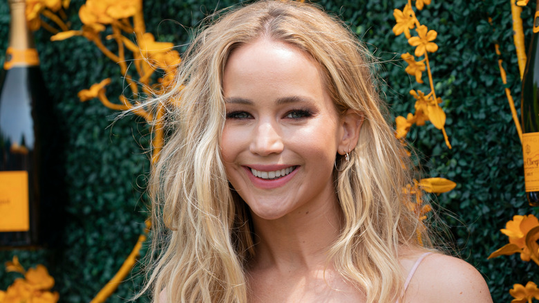 Jennifer Lawrence smiling in front of display