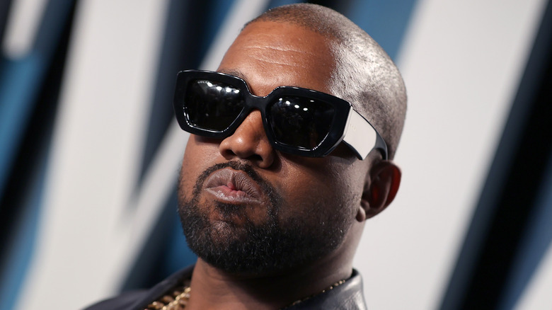 Kanye West wearing dark glasses