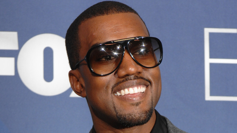 Kanye West wearing black frames, smiling