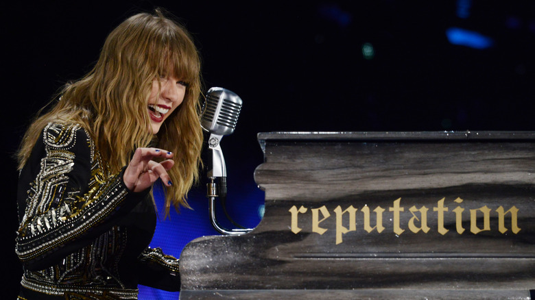 Taylor Swift laughing at piano on Reputation tour