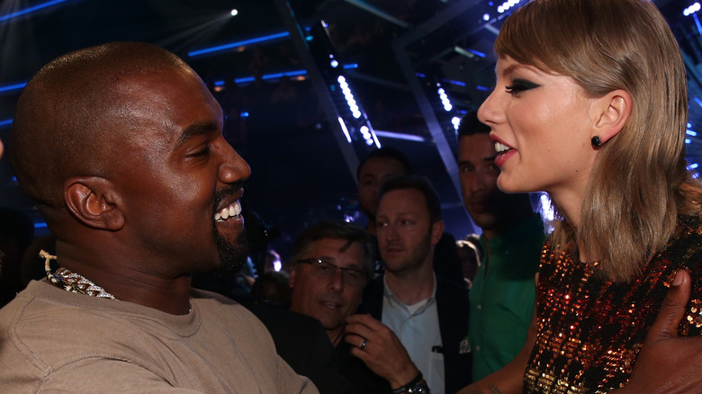 Kanye West and Taylor Swift laughing together at 2015 VMAs