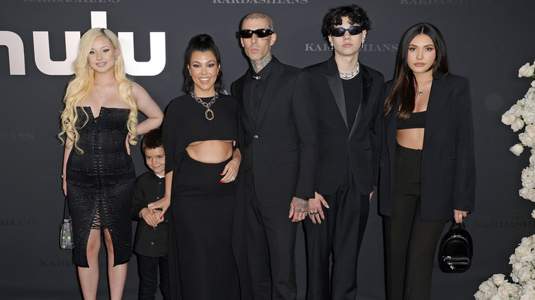 Travis Barker and family and Kourtney Kardashian, posing