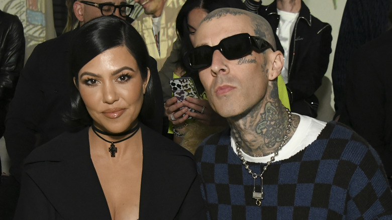 Kourtney Kardashian and Travis Barker both posing