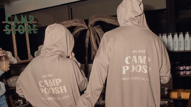 Travis Barker and Kourtney Kardashian in Poosh hoodies