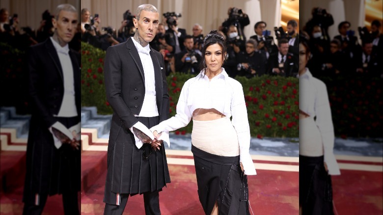 Kourtney Kardashian and Travis Barker posing at the Met