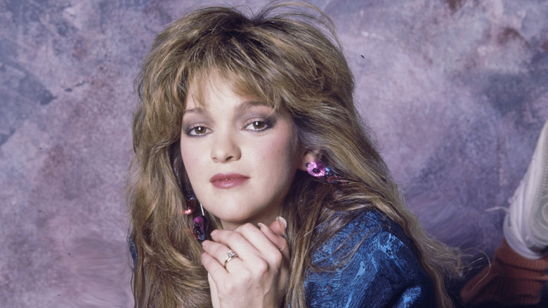 Valerie Bertinelli posing against purple background