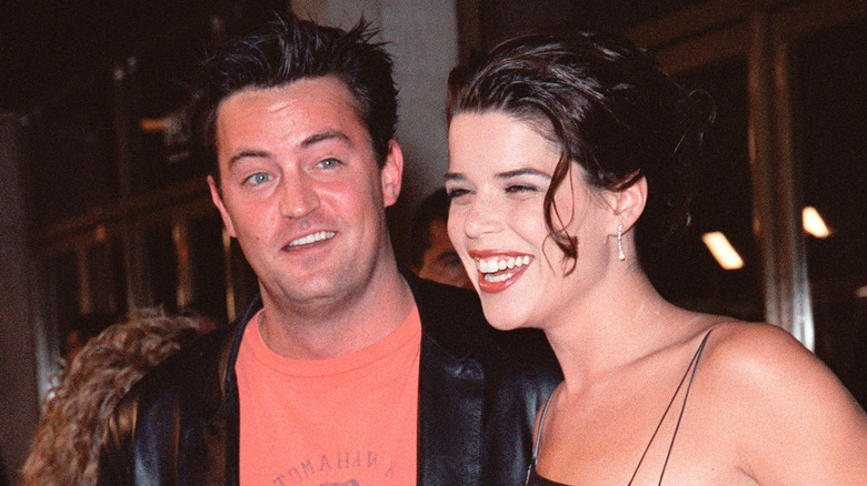 Neve Campbell and Matthew Perry both laughing