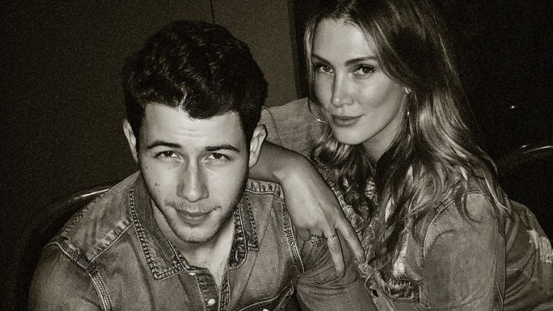 Nick Jonas and Delta Goodrem pose in matching denim