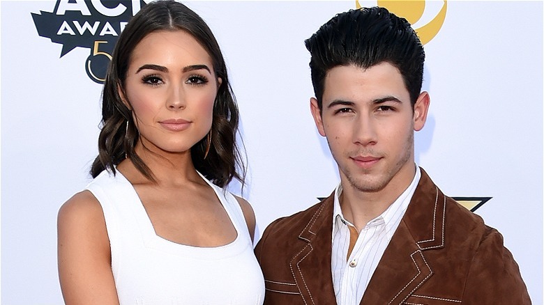 Olivia Culpo and Nick Jonas on an awards-show red carpet