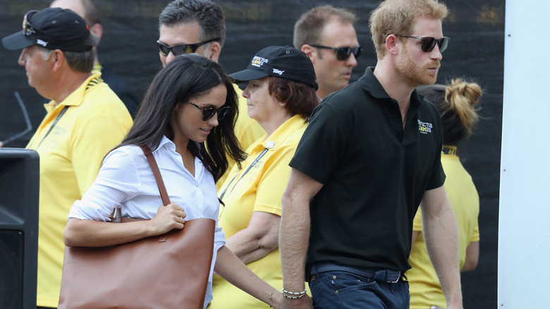 Meghan Markle and Prince Harry holding hands in Toronto, Canada