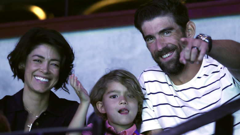 Michael, Nicole, and Boomer Phelps in the stands